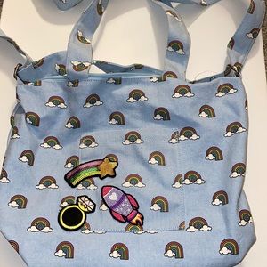 Cute big light blue and rainbow covered bag.